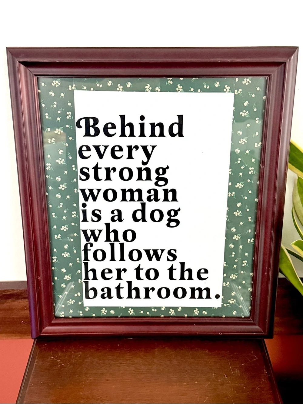 Behind Every Strong Woman is a Dog That Follows Her to the Bathroom Framed Art